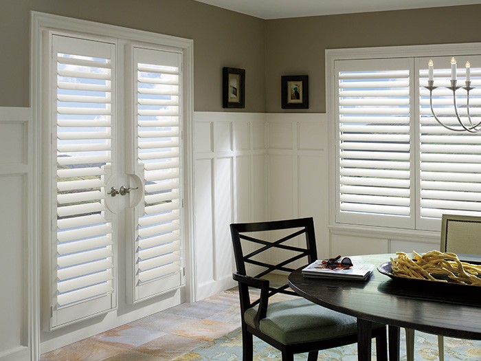 Dining room doors and windows featuring Palm Beach™ Polysatin™ Shutters
