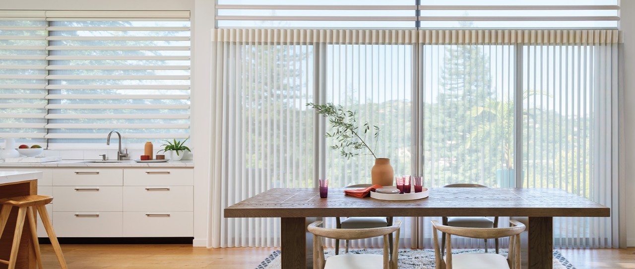 A white kitchen with open wood shelving filled with containers, bowls, and plants.